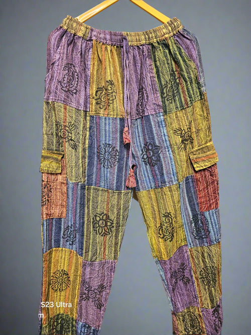 Colorful patchwork pants with floral patterns on a zigzag background